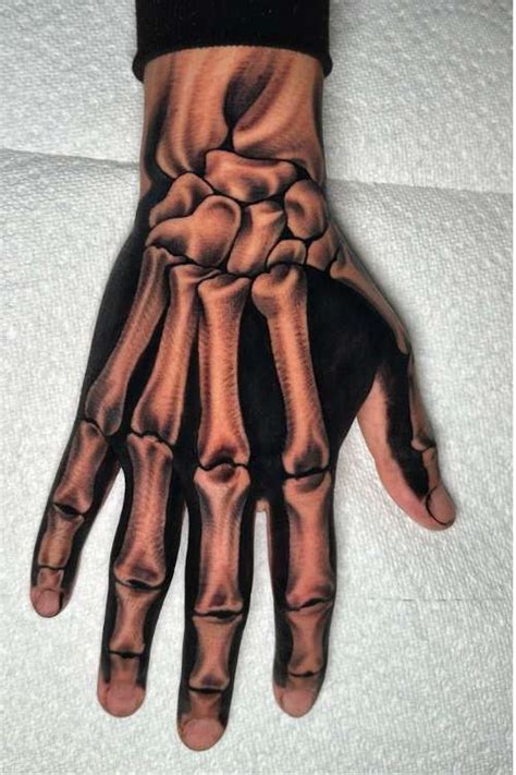 18 Terrifying And Cool Skeleton Hand Tattoo Design 18 Terrifying And Cool Skeleton Hand Tattoo Design