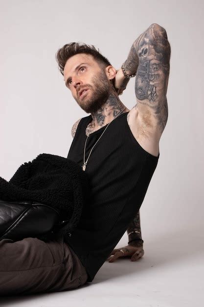 A Man With A Tattoo On His Arm