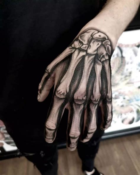 Bones In Hand Tattoo Design