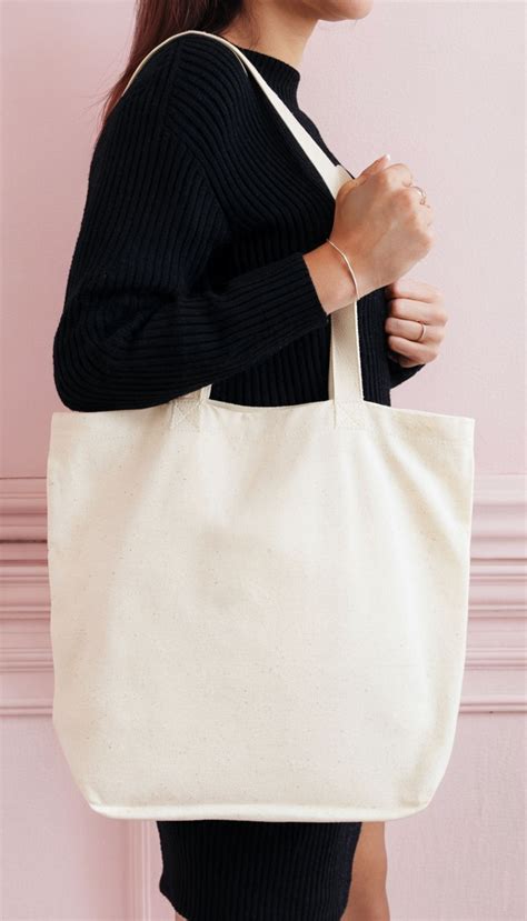 Elegant Woman Holding Blank Canvas Tote Bag Mockup Playground Elegant Woman Holding Blank Canvas Tote Bag Mockup Playground