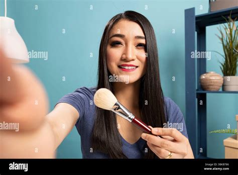 Fashion Blogger Recording A Livestream Tutorial Presenting Makeup Tools And Engaging Her Fashion Blogger Recording A Livestream Tutorial Presenting Makeup Tools And Engaging Her