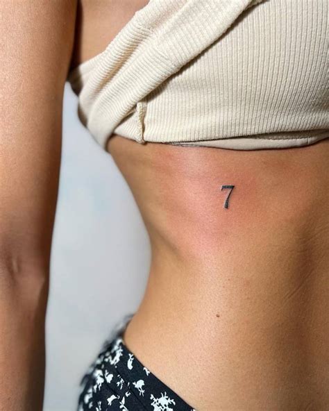 Minimalistic Number 7 Tattoo Located On The Rib Minimalistic Number 7 Tattoo Located On The Rib