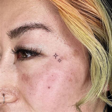 Tiny Stars Tattoo Located On The Face Minimalistic Tiny Stars Tattoo Located On The Face Minimalistic