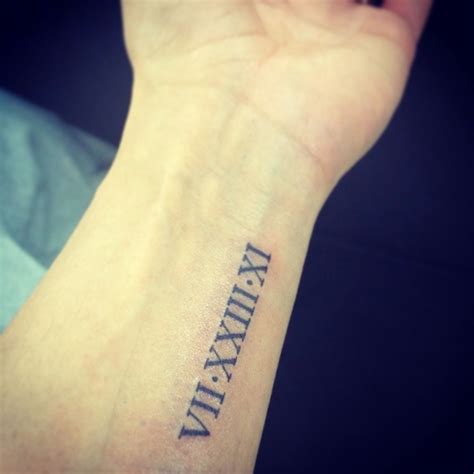 Wrist Tattoo Of The Number Five In Roman Numerals On